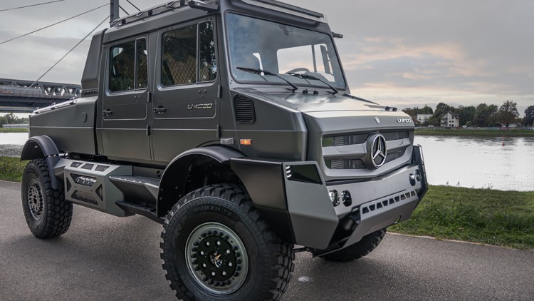 Das Unimog-Showcar von Mercedes-Benz Spezial Trucks parkt an einem Fluss. Das Fahrzeug ist in der seitlichen Frontansicht zu sehen